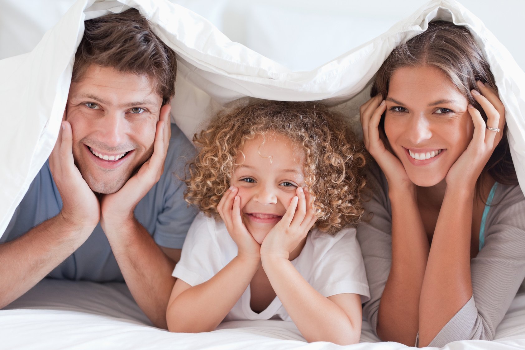 Family posing under a duvet